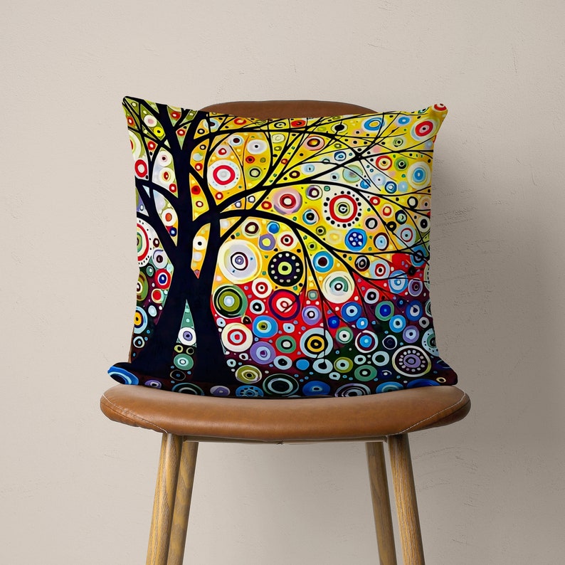 May include: A colorful throw pillow with a black tree silhouette and a background of yellow, red, blue, green, and purple circles.