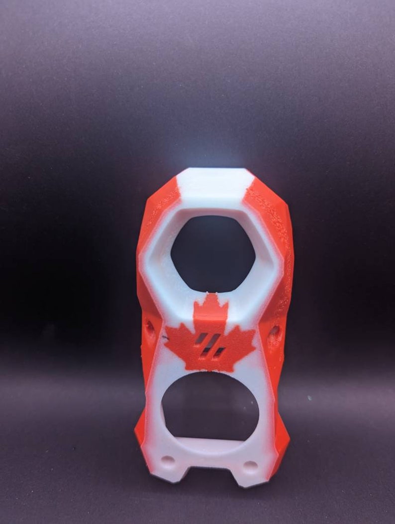 May include: A 3D printed phone case with a Canadian flag design. The case is white with red accents and a maple leaf design.