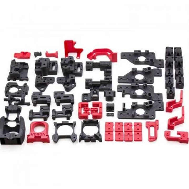 May include: A set of 3D printed parts in black and red. The parts are various shapes and sizes, and some have the word "VORON" printed on them.