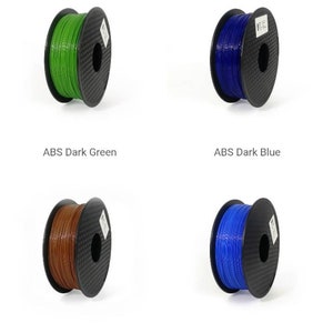 May include: Spools of ABS filament in various colors, including graphite, maroon, dark green, dark blue, brown, blue, bronze, and black.