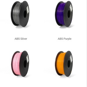 May include: Assortment of 10 spools of ABS filament for 3D printing in various colors, including sky blue, red, silver, purple, pink, orange, natural, and green.