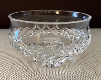 May include: A clear glass bowl with a cut crystal design and a short, round pedestal base.