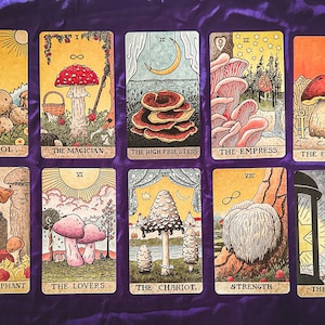 May include: A set of 10 tarot cards featuring illustrations of various mushrooms. Each card has a Roman numeral and a title, such as "The Fool", "The Magician", and "The Empress".