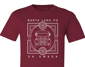 May include: A maroon t-shirt with a white graphic design. The design features a vintage jeep with the words "Barya Lang Po Sa Umaga" in a decorative frame.