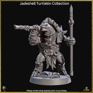 May include: A grey 3D printed miniature of a turtlekin warrior holding a spear and a pipe. The turtlekin is wearing a headdress and armour. The miniature is standing on a round base.