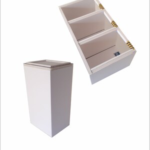 May include: Two white cardboard boxes. One box is a tall rectangular shape with a flat top. The other box is a smaller rectangular shape with three shelves. The shelves have yellow and black caution tape on the edges.