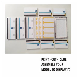 May include: A printable papercraft model of a parking garage with a white background. The model includes a variety of pieces, including walls, floors, and parking spaces. The model is labeled with the letters "P", "A1", "A2", "A3", and "d".