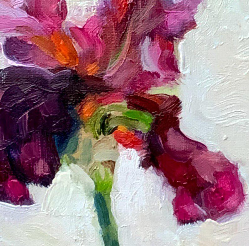 May include: Close-up of an oil painting of an iris flower. The petals are a deep purple and magenta, with hints of orange and green. The background is white, and the stem is green. The painting has a textured, impressionistic style.