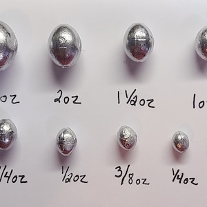 May include: A set of ten silver fishing sinkers, ranging in size from 1/8 ounce to 3 ounces. Each sinker is marked with its weight in ounces.