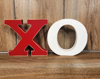 XO! Free standing wood letters representing a kiss and a hug. It's a perfect Valentine's, anniversary, or wedding gift.