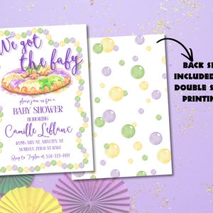 May include: A baby shower invitation with a Mardi Gras theme. The front features a watercolor king cake and text that reads "We got the baby." The back has a pattern of pastel bubbles. The invitation is for Camille Leblanc.