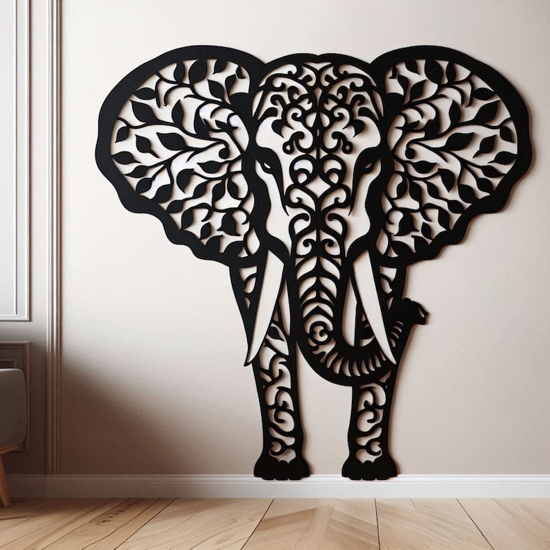 May include: Black elephant wall art with intricate leaf and swirl cut-out design. The elephant's ears and body are detailed with a decorative pattern. This wooden wall decor adds a unique touch to any room.