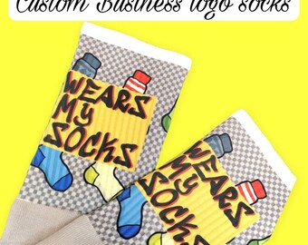 May include: A pair of gray and white socks with a checkered pattern. The socks feature a yellow and red graphic that says "Wears My Socks".