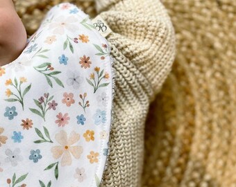 Floral bibs on white cotton