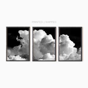 May include: A set of three black and white framed prints featuring a close-up of fluffy clouds against a dark sky.