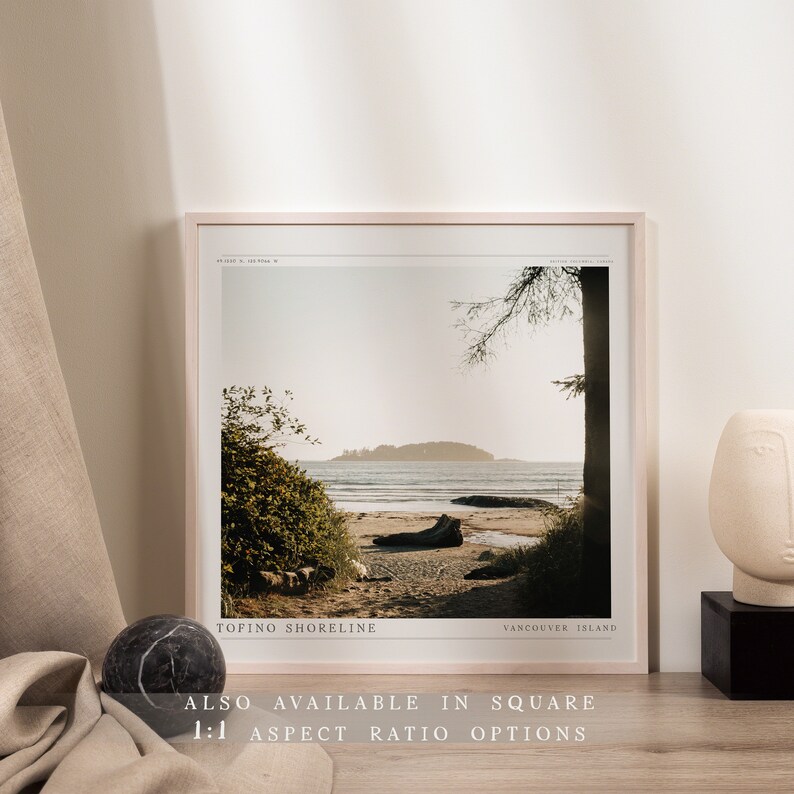 May include: A framed photograph of a beach scene with a wooden log in the foreground. The text "Tofino Shoreline" and "Vancouver Island" is printed at the bottom of the image.