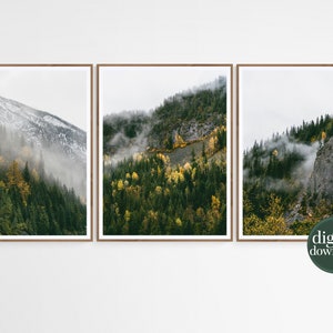 May include: A set of three digital prints featuring a misty mountain landscape with green and yellow trees. The prints are framed in a simple wooden frame.