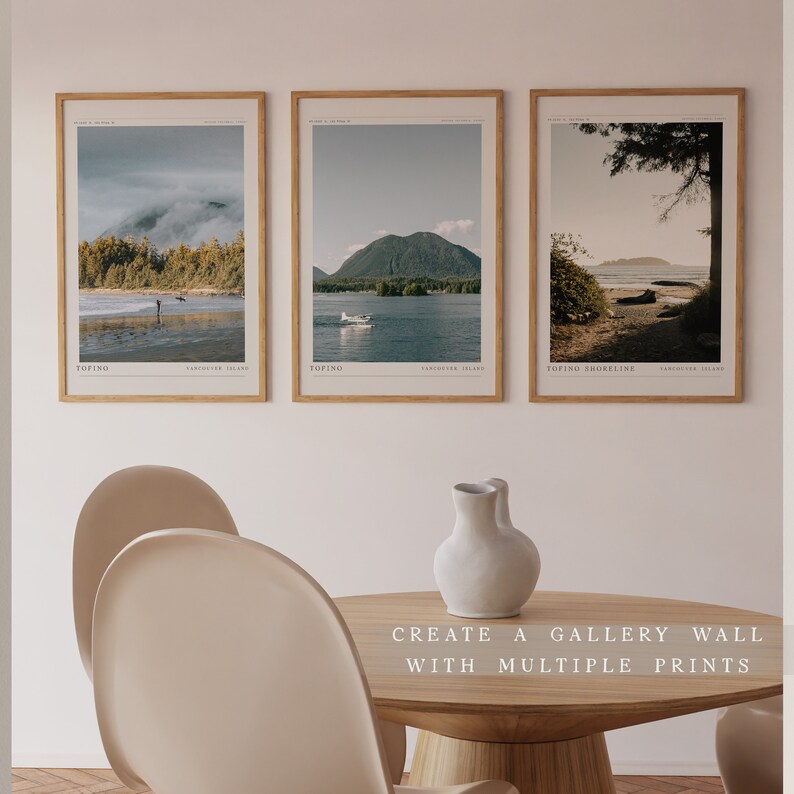 May include: Three framed landscape photographs of the Tofino coastline in British Columbia, Canada. The photos are hung on a white wall above a wooden table with a white vase. The text "CREATE A GALLERY WALL WITH MULTIPLE PRINTS" is printed below the table.