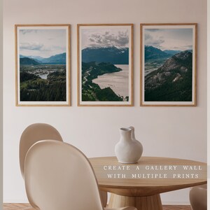 May include: Three framed landscape photographs of mountains, water, and forests. The photos are arranged in a row on a white wall. The text "CREATE A GALLERY WALL WITH MULTIPLE PRINTS" is below the photos.