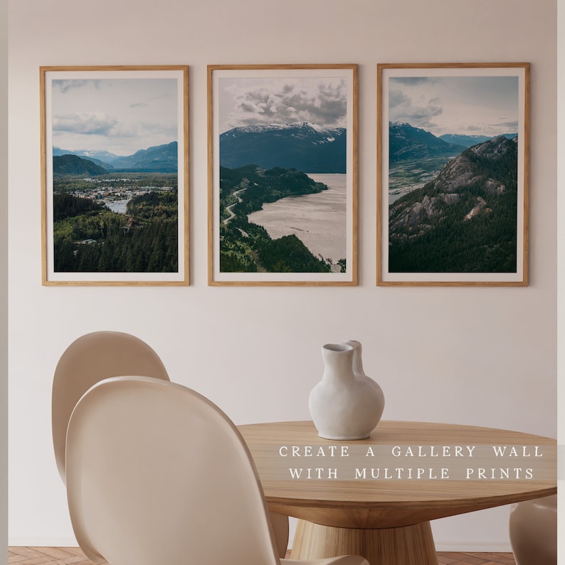 May include: Three framed landscape photographs of mountains, water, and forests. The photos are arranged in a row on a white wall. The text "CREATE A GALLERY WALL WITH MULTIPLE PRINTS" is below the photos.