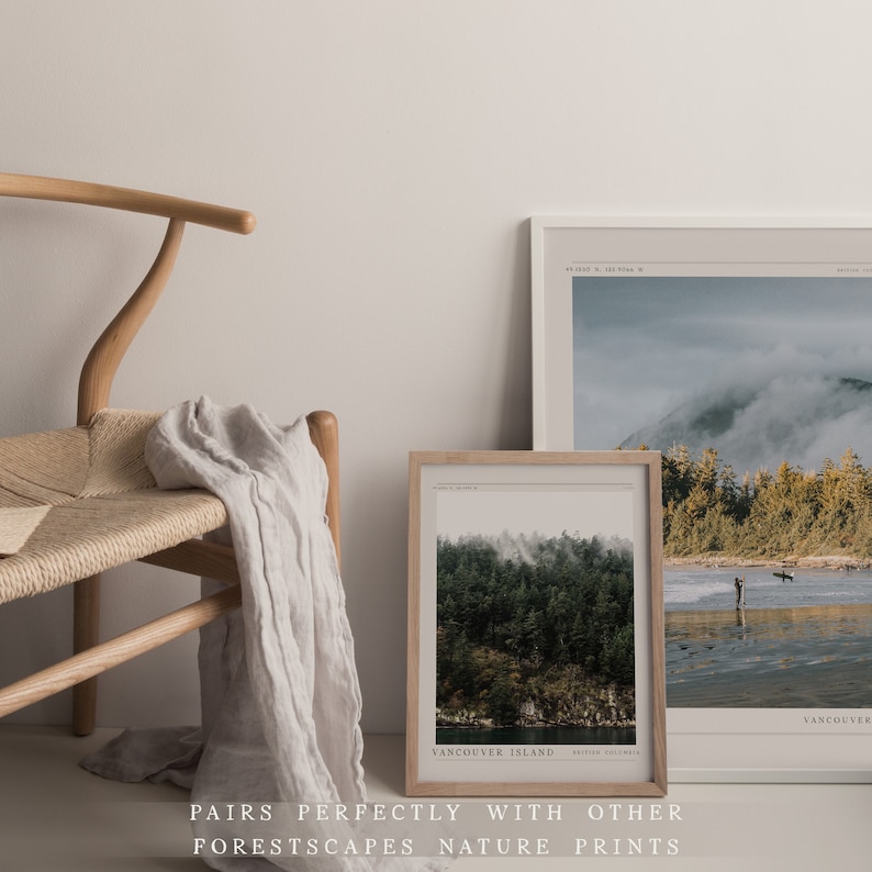 May include: Two framed nature prints with a misty forest scene. The top print shows a mountain range with a misty forest in the foreground. The bottom print shows a closer view of a misty forest with a body of water in the background. Both prints have a white background with black text that reads "Vancouver Island" and the coordinates of the location.