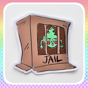 May include: A sticker depicting a cartoon green creature with a stern expression behind jail bars. The jail is a brown box with the word "JAIL" printed on it. The sticker has a white border.