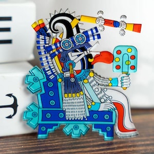 Itztlacoliuhqui acrylic pin - Mexica (Aztec) snow diety