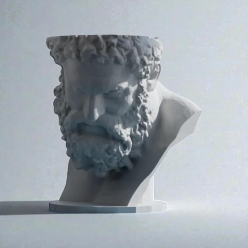 May include: A white sculptural planter shaped like the head of a bearded man with curly hair. The top of the head is open, creating a hollow vessel for plants. The sculpture features detailed facial features, including a thick beard and mustache.