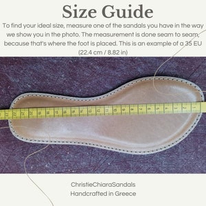 May include: A close-up of a leather sandal insole with a yellow measuring tape showing a measurement of 22.4 cm or 8.82 inches. The text "Size Guide" is at the top of the image. The text "ChristieChiaraSandals Handcrafted in Greece" is at the bottom of the image.