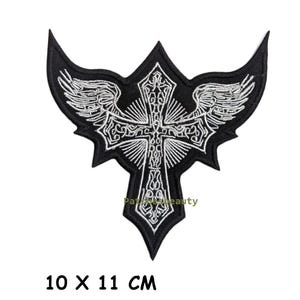May include: Black and white embroidered patch featuring a cross design with wings. The patch measures 10 x 11 cm (approximately 3.9 x 4.3 inches). The text "Paris & beauty" is visible on the patch.