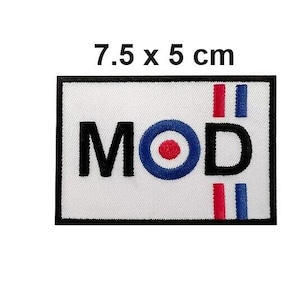 May include: A rectangular patch with the word "MOD" in black letters, a blue and red target symbol, and red and blue vertical stripes. The patch is 7.5 x 5 cm (approximately 3 x 2 inches) and has a black border.