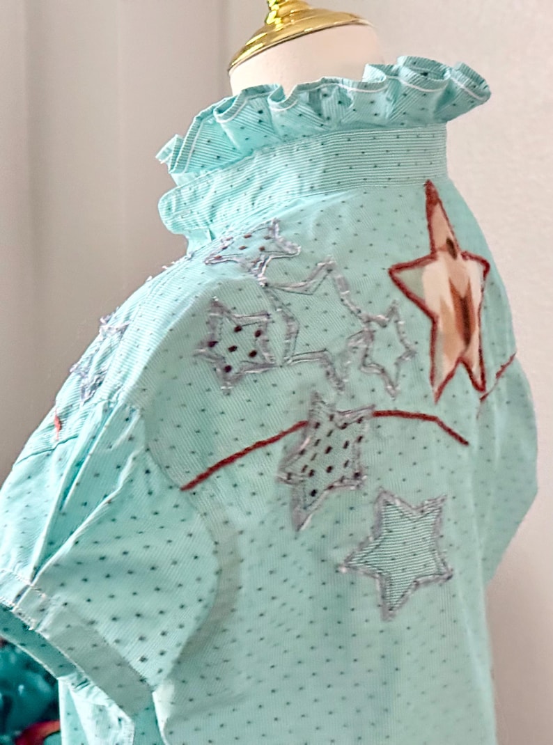 May include: A white ceramic mug with a black handle and the text "But First, Coffee" in a black, handwritten-style font. The mug is on a white surface.