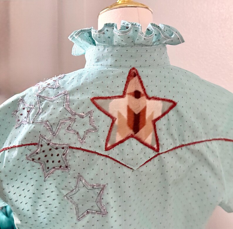 May include: A white ceramic mug with a black handle and the text "But First, Coffee" in a black, bold font. The mug is on a white surface.