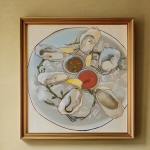May include: A framed painting of a plate of oysters with lemon wedges and dipping sauces. The oysters are arranged in a circle around the plate, with the sauces in the center. The painting is done in a realistic style, with a focus on the details of the oysters and sauces.