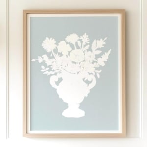 May include: A white silhouette of a bouquet of flowers in a vase against a light blue background.
