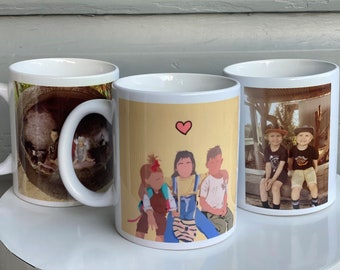 May include: Three white ceramic mugs with different designs. The first mug has a photo of a person with a hat and a brown background. The second mug has a photo of three people with a yellow background and a pink heart. The third mug has a photo of two people with a brown background.