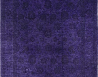 May include: A rectangular, deep purple rug with a floral pattern. The rug features a darker purple border and a central field filled with stylized floral motifs. The design is consistent throughout, creating a cohesive and elegant look.
