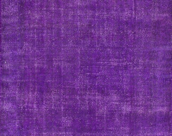 May include: A solid purple rug with a slightly distressed, textured surface.