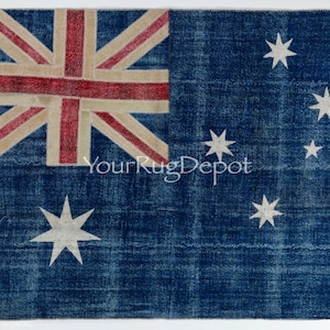 May include: A blue rug with the Australian flag design. The rug features a Union Jack in the upper left corner with red and beige stripes. The Southern Cross constellation is depicted with white stars on the right side. The text "YourRugDepot" is visible.