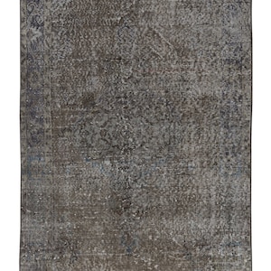 May include: A vintage rug with a faded blue and brown pattern. The rug has a distressed look and a worn border.
