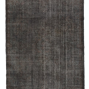May include: A dark gray vintage rug with a faded pattern. The rug has a distressed look and is made of a soft, woven material.