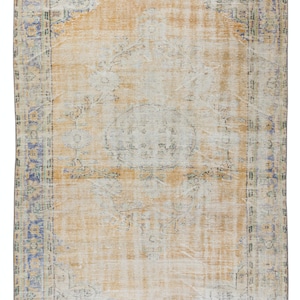 May include: A vintage rug with a faded floral pattern in shades of blue, green, and beige. The rug has a distressed look and a worn border.