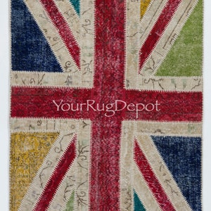 May include: A patchwork rug with a Union Jack design. The rug is made of different colored fabrics, including red, white, blue, green, and yellow. The rug is a vintage style and has a distressed look.