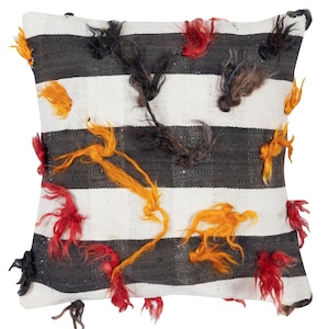 May include: Square decorative pillow with a striped black and white pattern. The pillow features tufts of red, orange, and black yarn scattered across the surface, adding texture and visual interest. A stylish accent piece for any room.