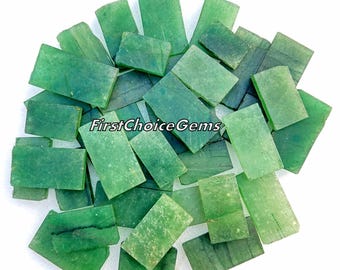 May include: A collection of rectangular green gemstone slabs with varying textures and natural inclusions. The stones are arranged in a cluster, and the text FirstChoiceGems is printed in black across the center of the group.