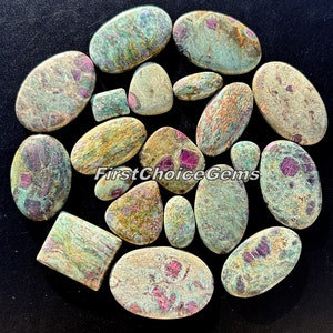 Può includere: Assortimento di 16 cabochon di pietre preziose verdi, rosa e marroni. I cabochon sono di forma ovale, rotonda e rettangolare. Le pietre hanno un motivo maculato con inclusioni rosa e bianche.