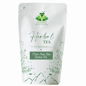 May include: White pouch of herbal tea with green text and graphics. The text reads "Herbal Tea" and "Maca Root Raw Herbal Tea". The brand logo is at the top, and the words "We Serve the Pure" are below it. The pouch has a mountain graphic at the bottom.