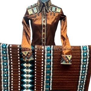 May include: A brown and turquoise patterned horse saddle pad with a brown and gold embroidered show shirt with turquoise and gold embellishments.
