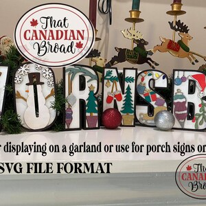 May include: A set of wooden letters spelling "HORNSEY" decorated with Christmas-themed designs, including a snowman, reindeer, ornaments, and a Christmas tree. The letters are on a white surface with a sign that reads "That CANADIAN Broad" in red and black text.