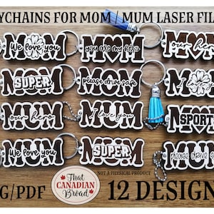 May include: Twelve laser cut designs for keychains featuring the word "Mom" or "Mum" with various phrases and designs. The designs include "We love you", "You are my hero", "Our hero", "Super", "Please drive safe", "I love you", "Sports", and more. The keychains are made of wood and have a brown stain.